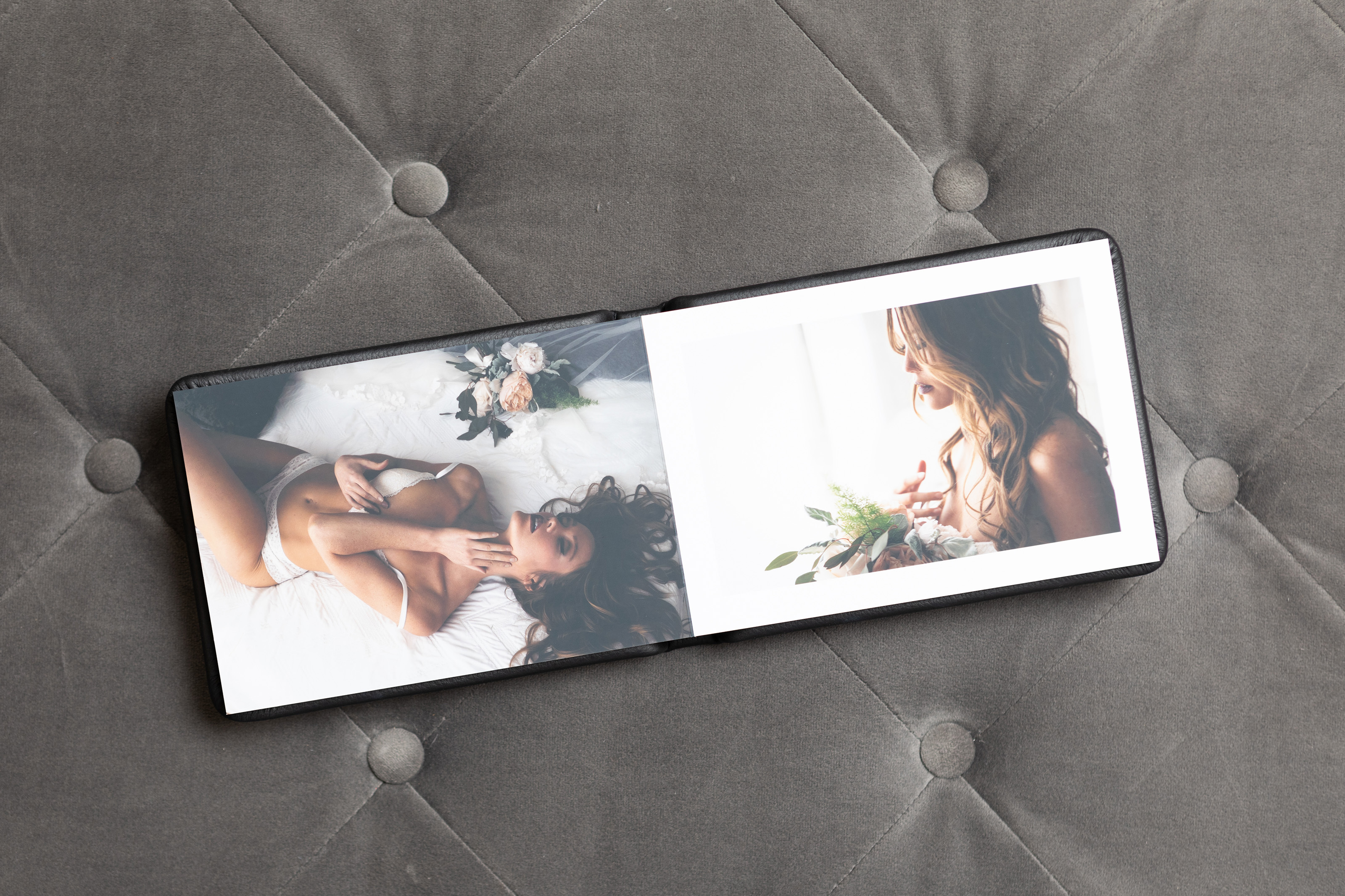 Boudoir Album open on a gray tufted fabric