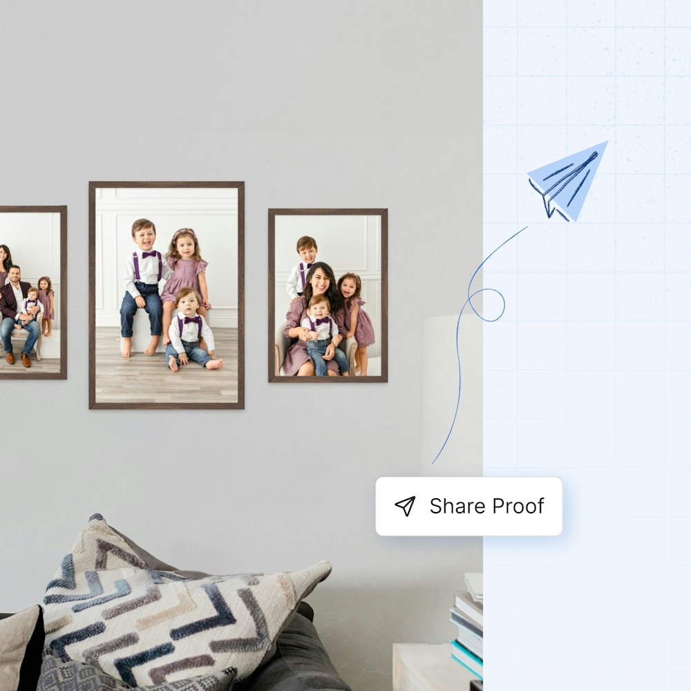 Three family portrait images in Woodland Framed Prints of different sizes on wall above couch, floating "Share Proof" button with paper airplane illustration