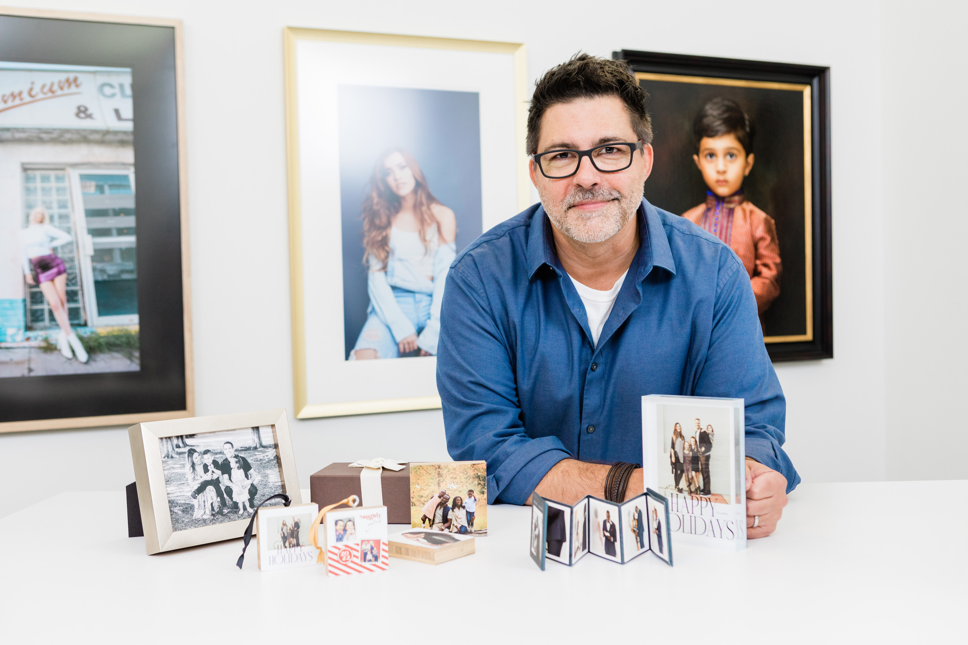 A man leaning on a table of display and gift products during a live YouTube recording session