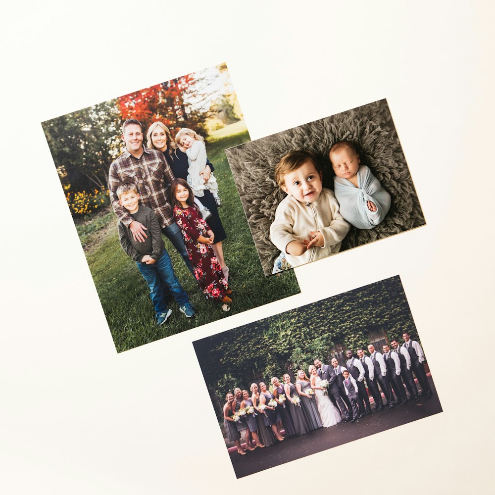 Three photo prints are arranged on a plain surface, featuring a family portrait, a newborn baby with a sibling, and a wedding group photo.