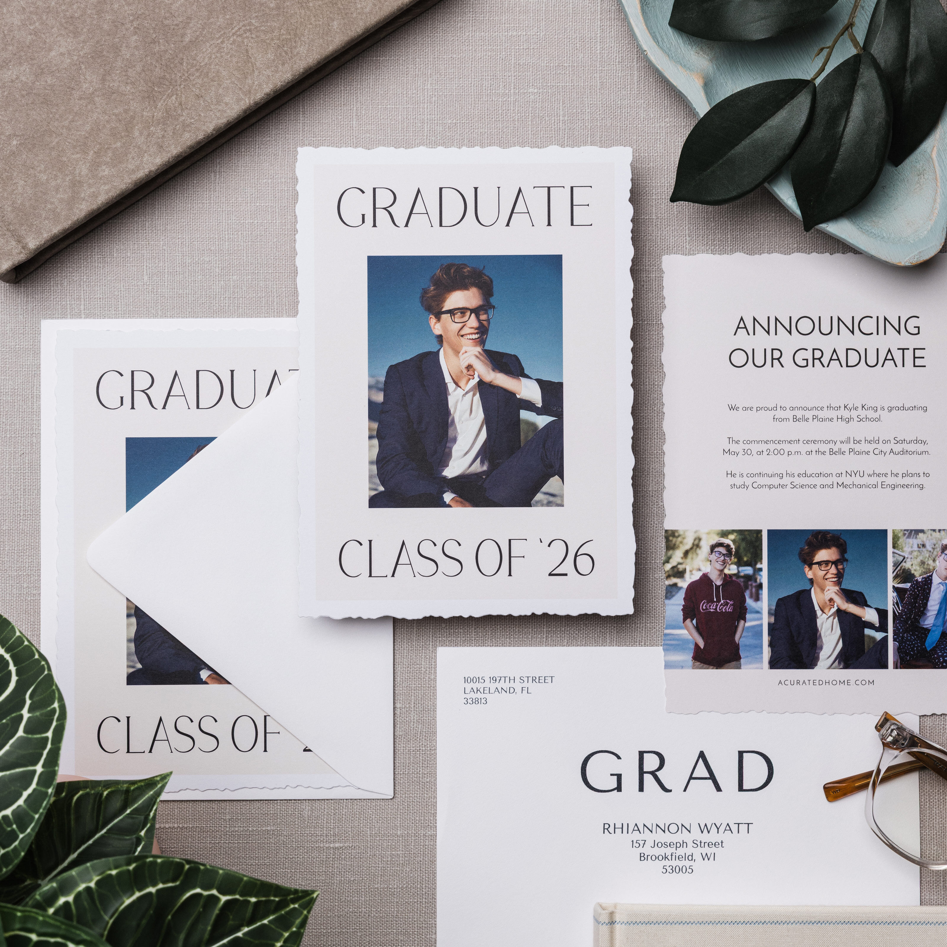 flat lay of professional graudate portrait in several graduation announcement cards with custom printed envelopes
