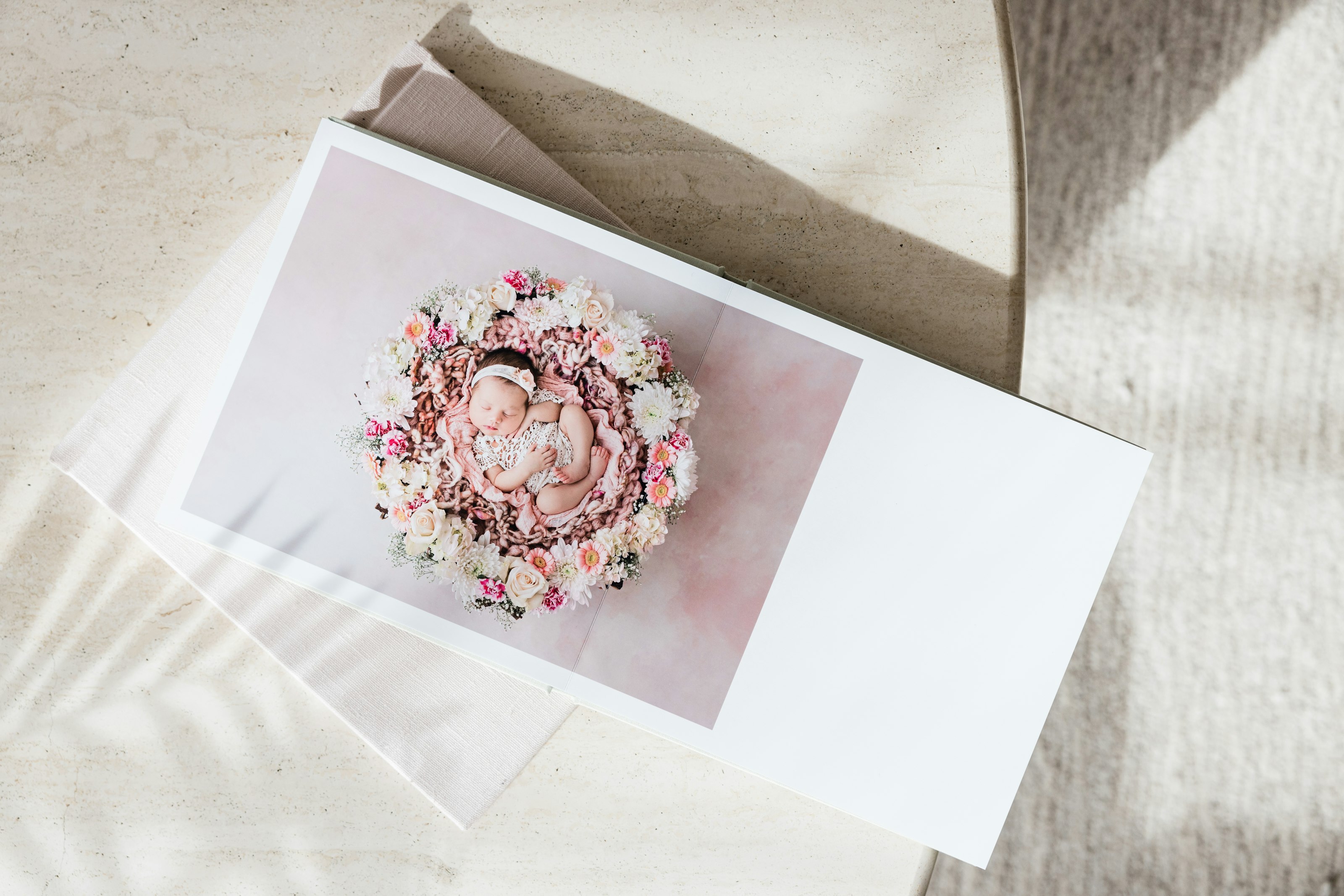 A newborn Photo Album laying open on a table.