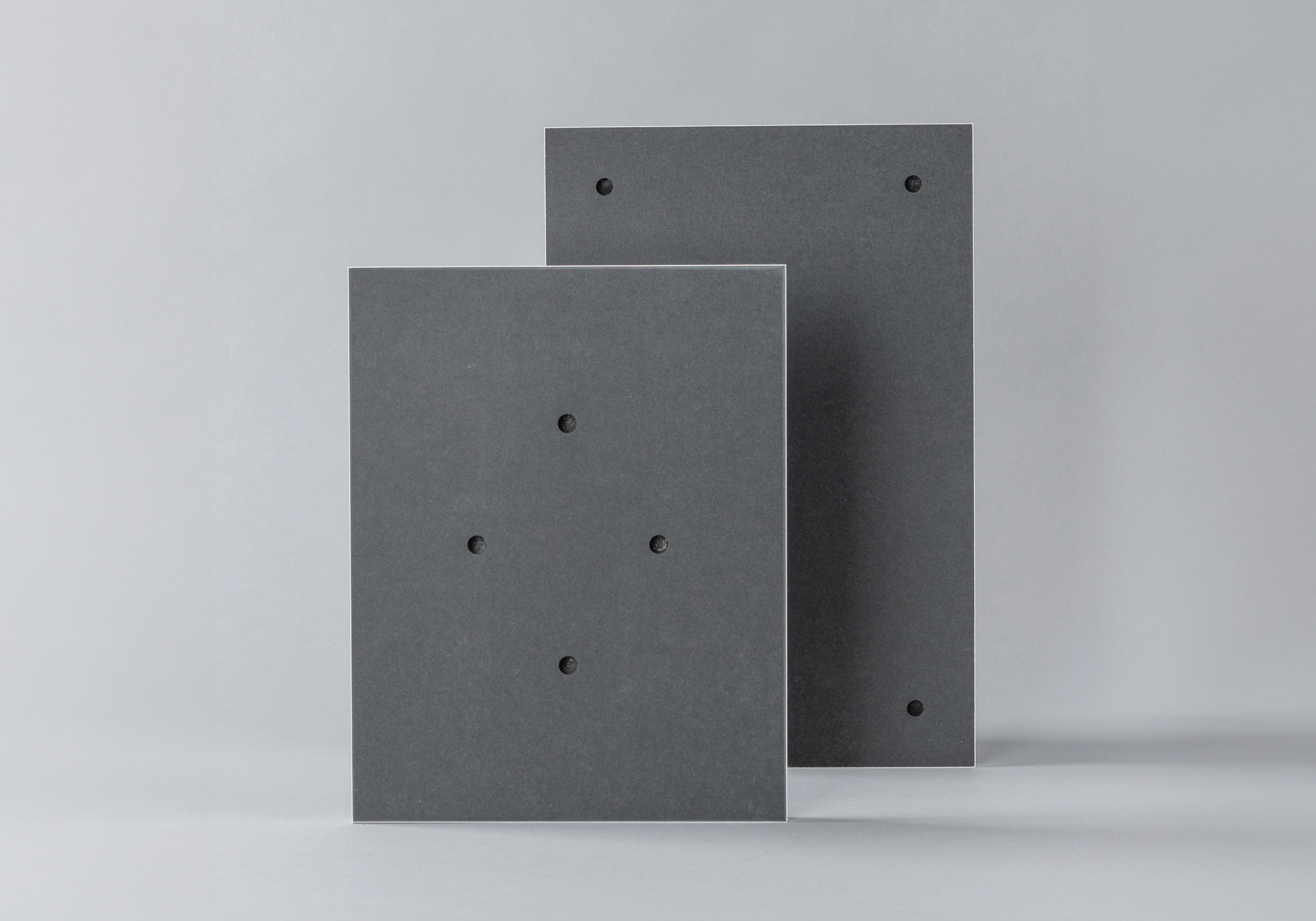 Back of two Standout prints highlighting the pre-drilled holes used to hang and display the prints on a wall.